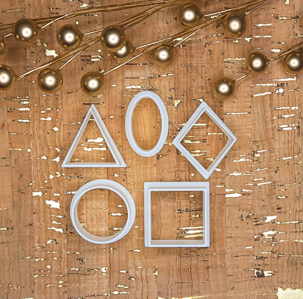 photo of clay cutters in the shapes of a triangle, oval, diamond, circle and a square